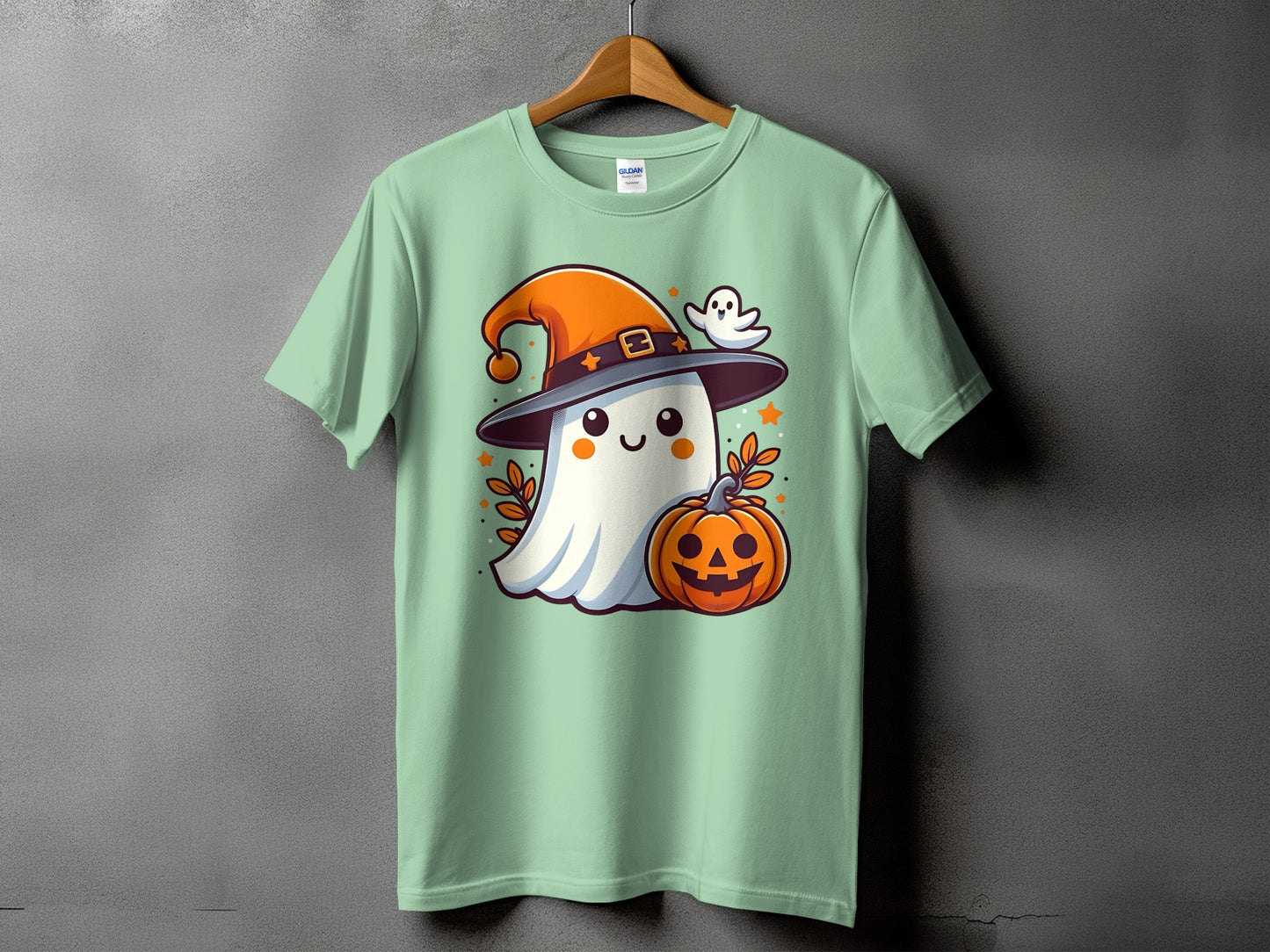 Green t-shirt with a cute ghost wearing a witch hat and holding a jack-o'-lantern.
