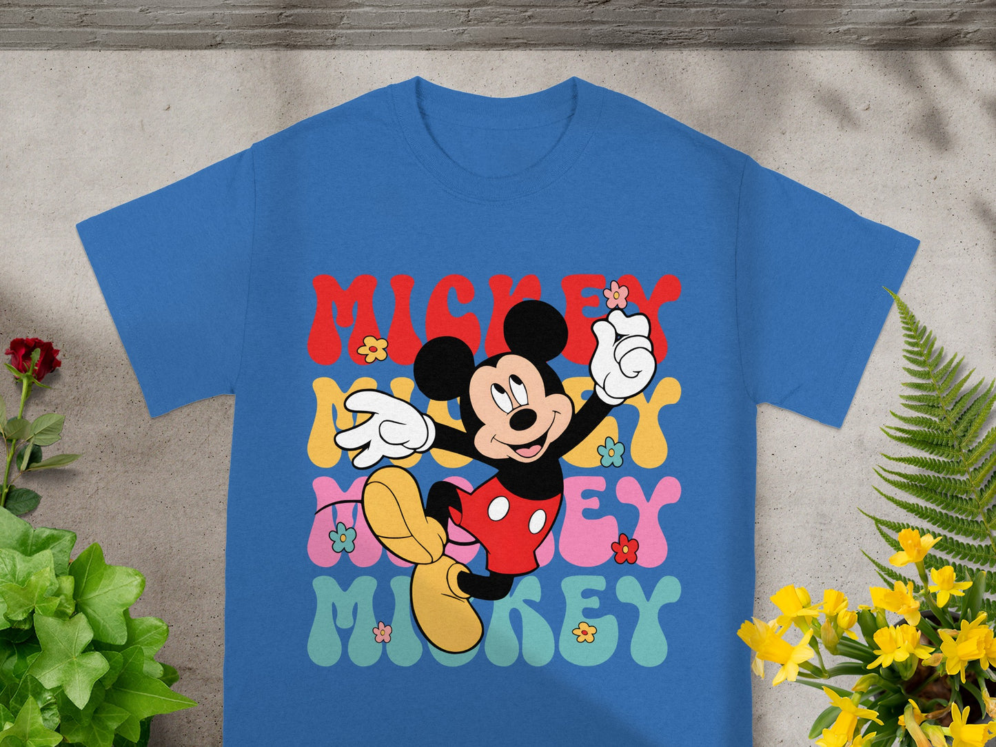 Blue t-shirt with "Mickey" in colorful wavy text and a smiling Mickey Mouse.