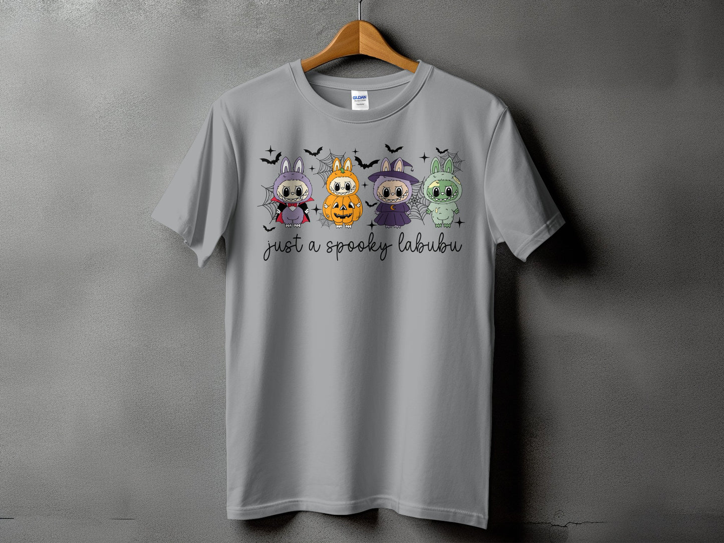 Grey t-shirt with four Halloween-themed Labubu characters and text.