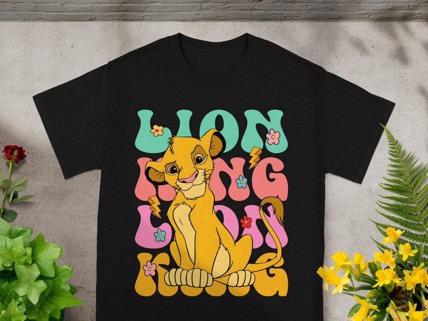 Simba from The Lion King on a black t-shirt with "Lion King" text.