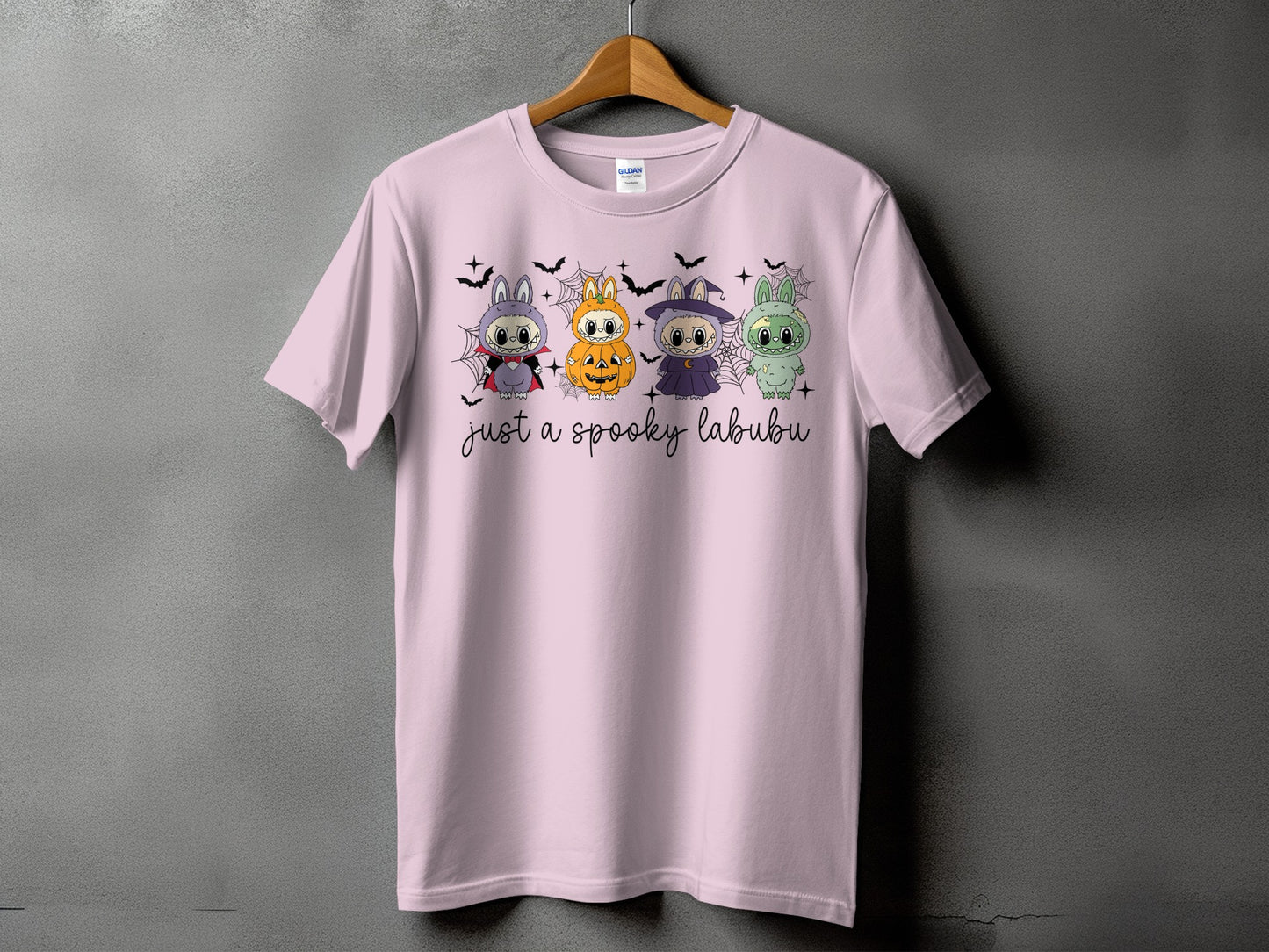 Pink t-shirt with four Halloween-themed Labubu characters and text "just a spooky labubu".