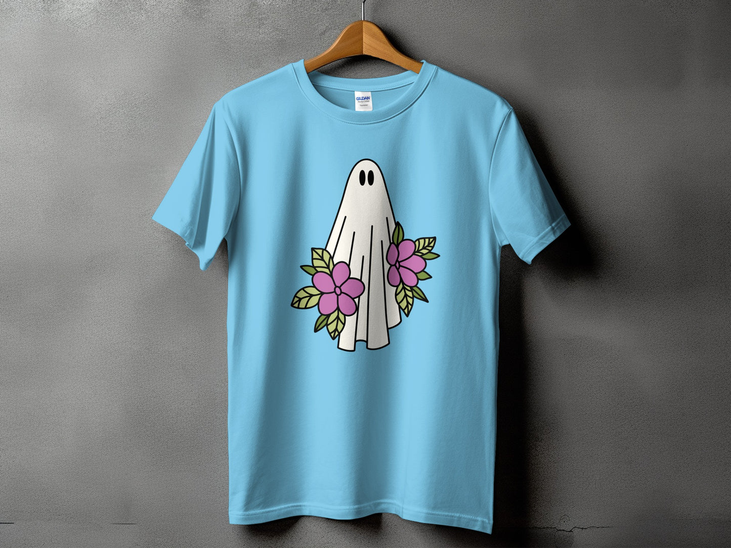 Light blue t-shirt with a white ghost graphic surrounded by pink flowers.