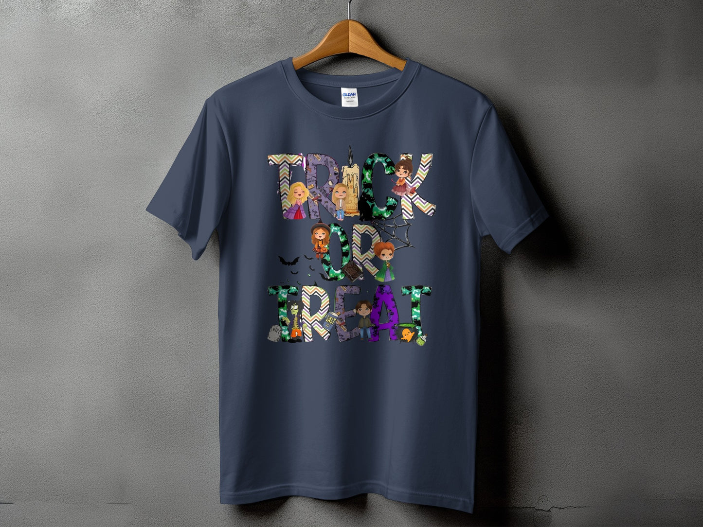Dark blue t-shirt with "Trick or Treat" text featuring cartoon characters and Halloween motifs.