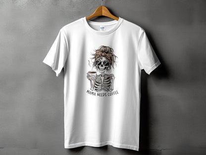 White t-shirt with skeleton graphic, leopard print bandana, sunglasses, and text "Mama Needs Coffee".