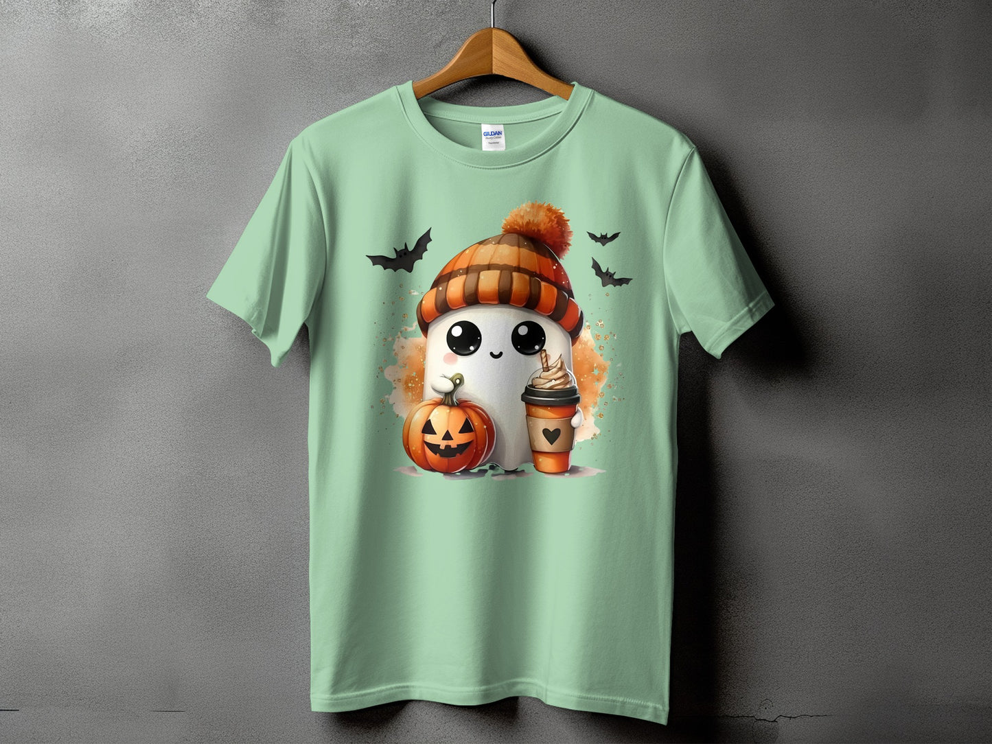 Ghost with pumpkin and coffee on a light green t-shirt with bats.