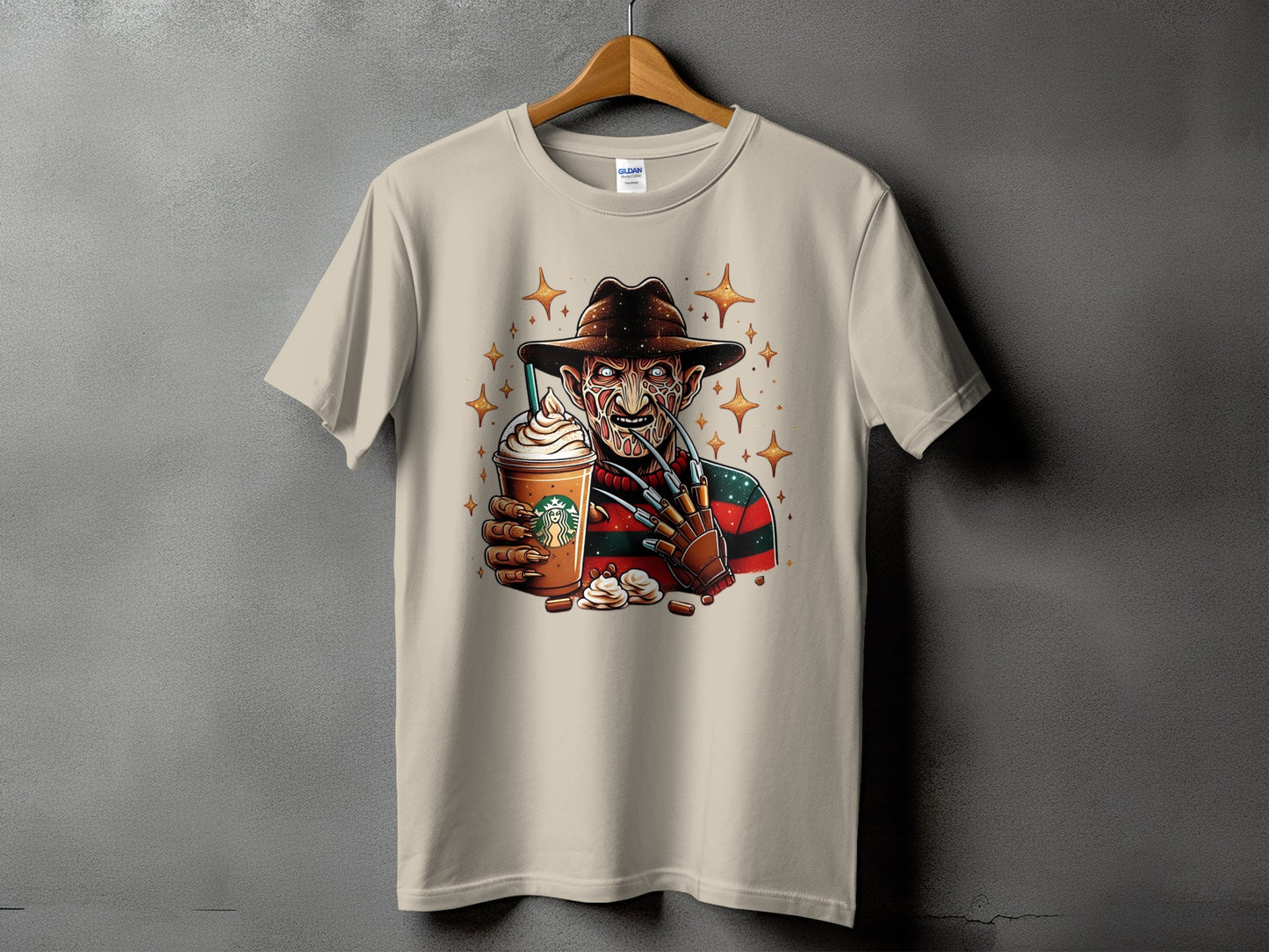 Freddy Krueger character holding a Starbucks cup on a tan t-shirt.