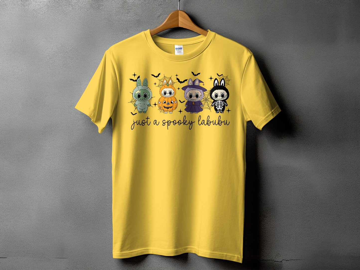 Yellow t-shirt with four cute Halloween characters and text "just a spooky labubu".