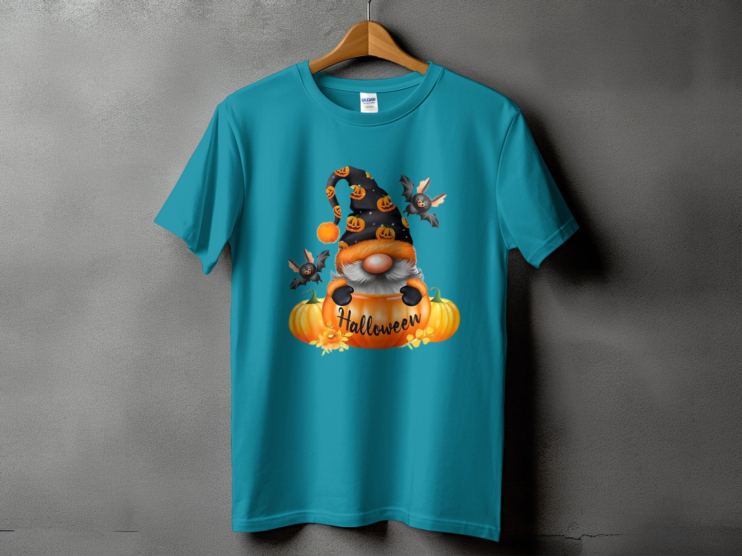 Turquoise t-shirt featuring a gnome in a pumpkin with bats and "Halloween" text.
