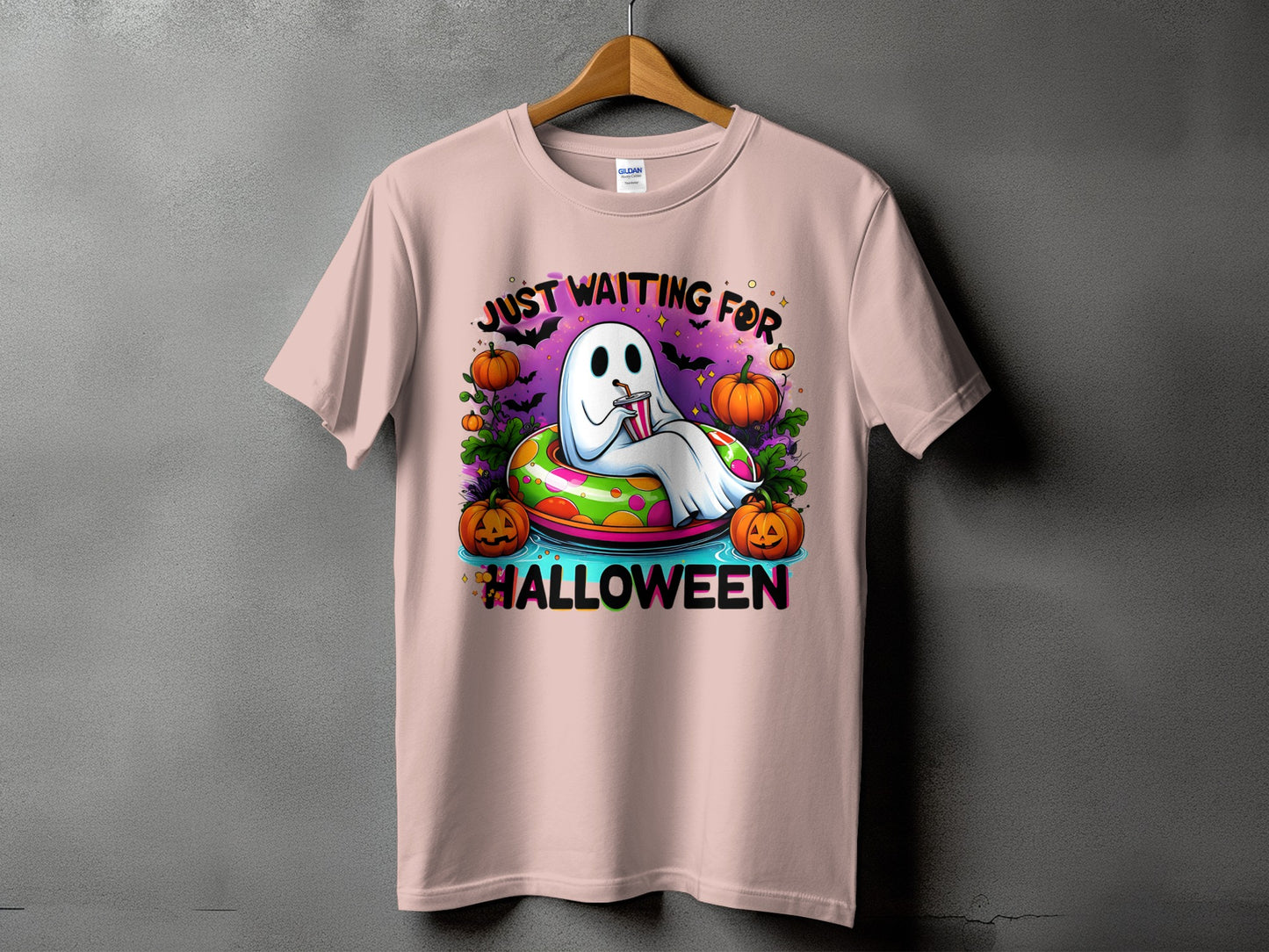 Ghost in inner tube with pumpkins and text "Just Waiting For Halloween".
