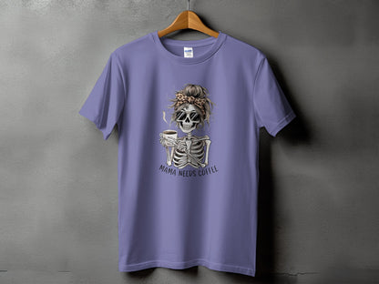 Skeleton graphic with sunglasses and coffee cup on a purple t-shirt, "Mama Needs Coffee" text.