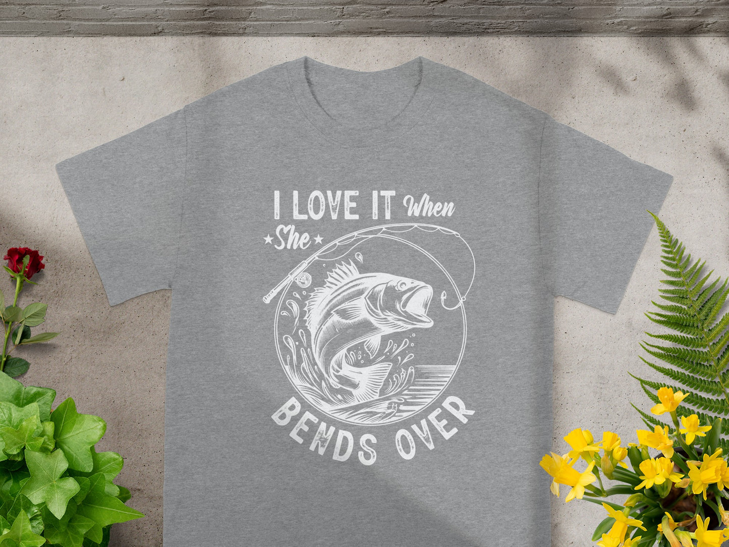 Grey t-shirt with white graphic of a jumping fish and text "I Love It When She Bends Over".
