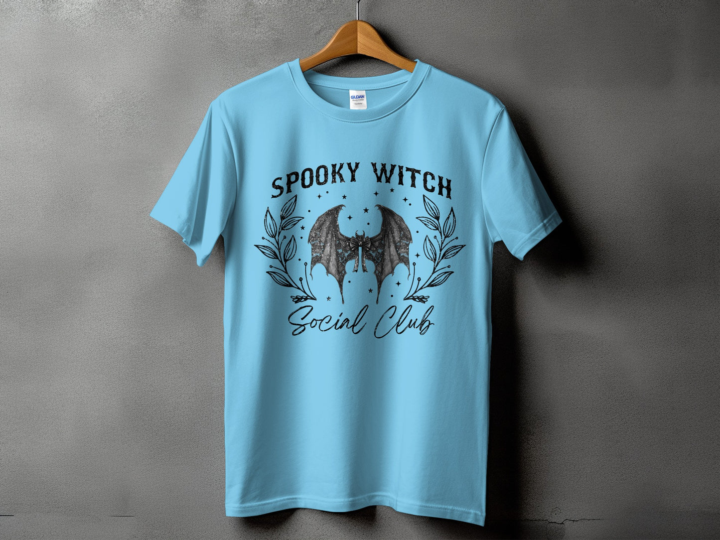 Light blue t-shirt with "Spooky Witch Social Club" and bat graphic.