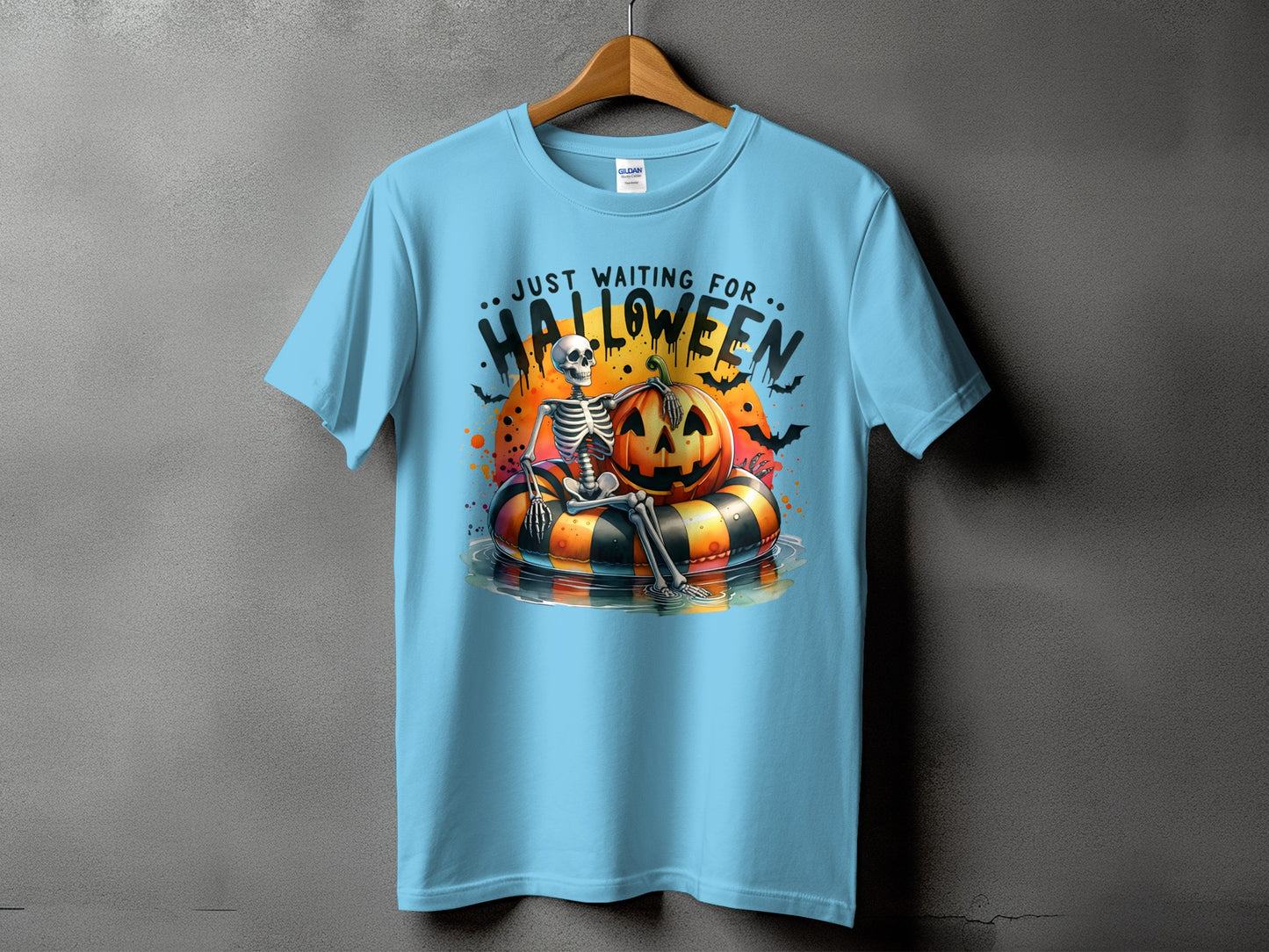 Skeleton on a pumpkin float with text "Just Waiting for Halloween"