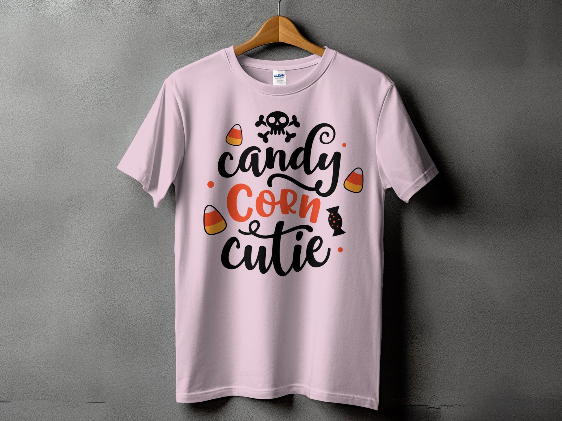 Pink t-shirt with "candy corn cutie" text and Halloween graphics.