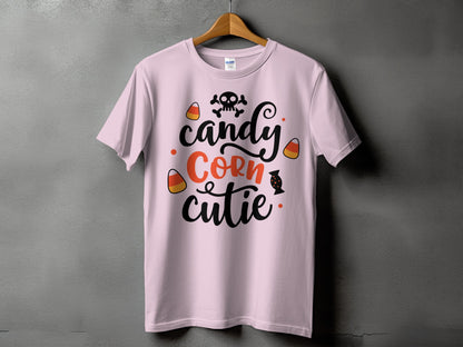 Pink t-shirt with "candy corn cutie" text and Halloween graphics.