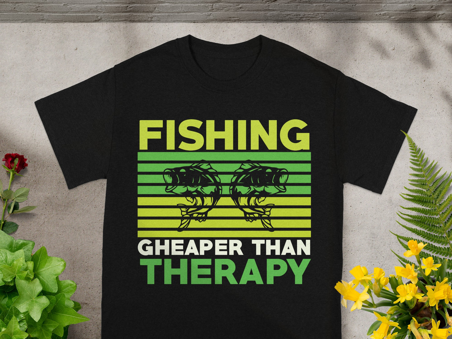 Black t-shirt with green text: Fishing Cheaper Than Therapy.