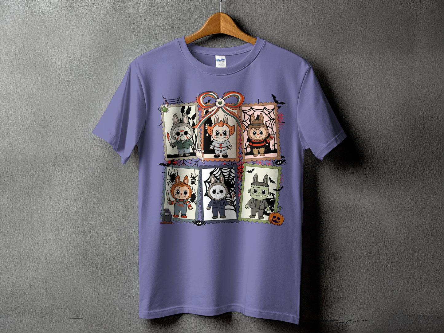 Purple t-shirt with six Halloween character postage stamp graphics and a bow.