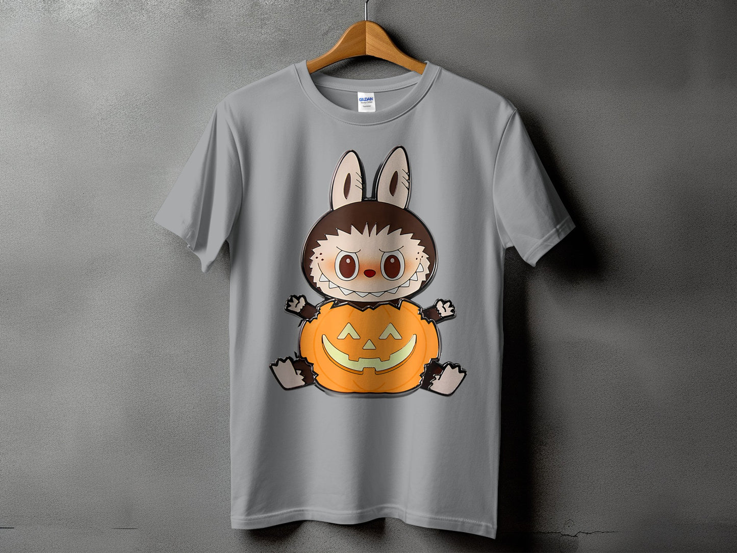 Grey t-shirt with a cartoon werewolf-like character sitting on a jack-o'-lantern.