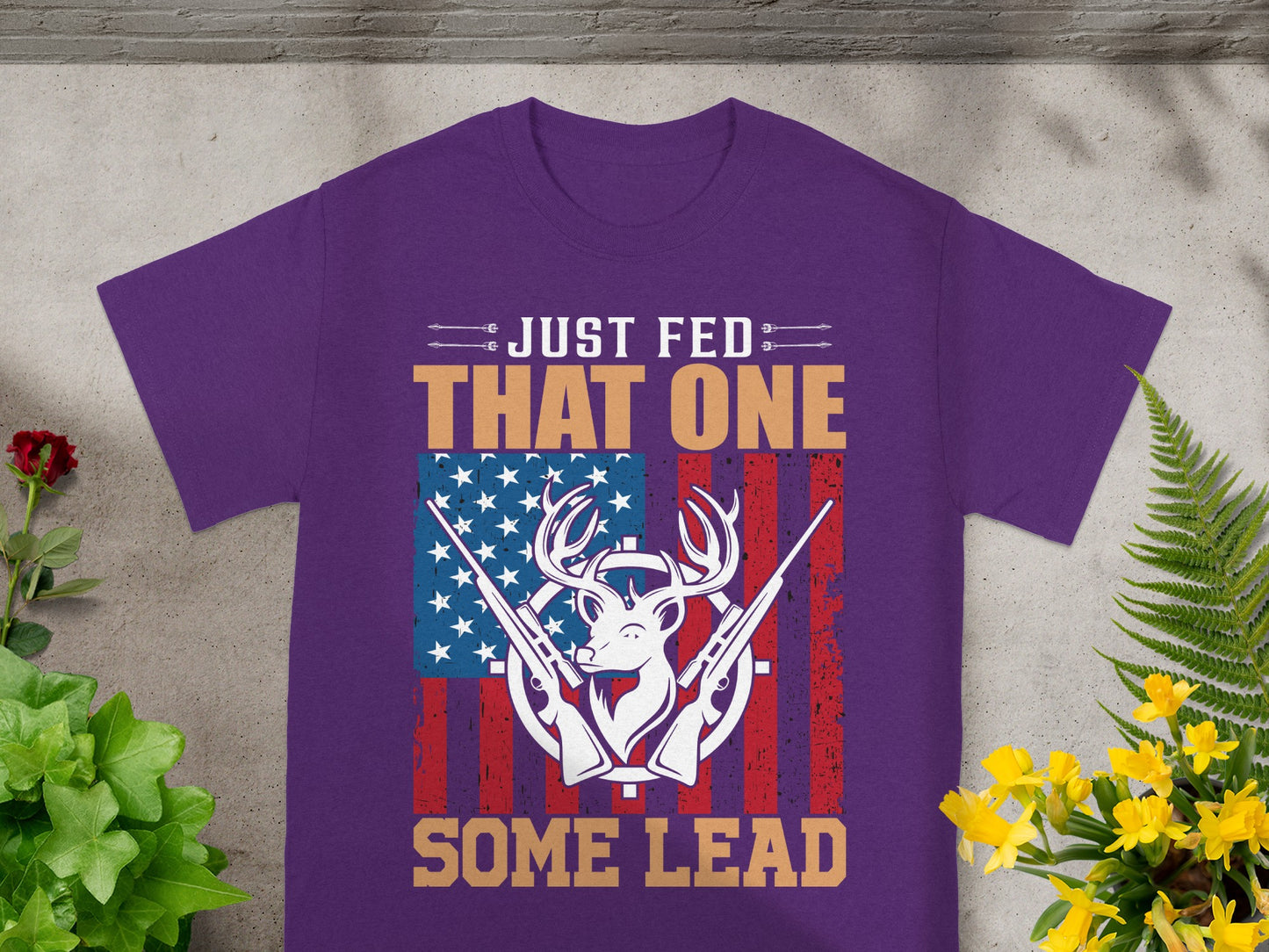 Purple t-shirt with "Just Fed That One Some Lead" text and deer graphic.