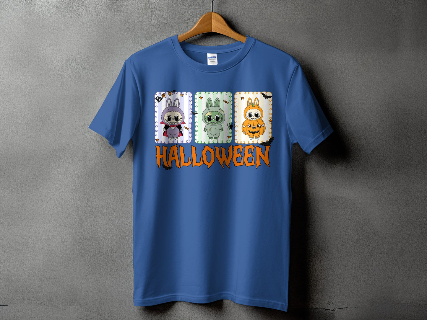 Blue t-shirt with three cartoon Halloween characters and the word "HALLOWEEN" in orange.