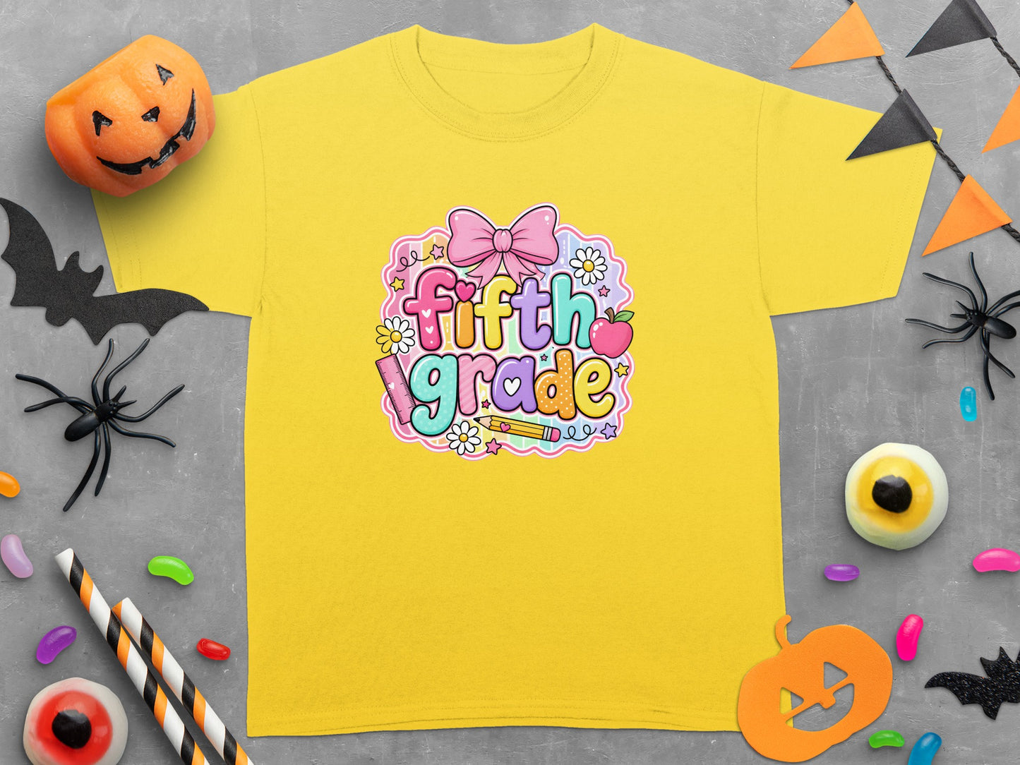 Yellow t-shirt with "fifth grade" text and Halloween decorations.