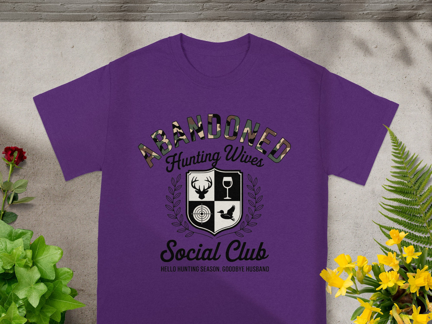 Purple t-shirt with "ABANDONED Hunting Wives Social Club" graphic.