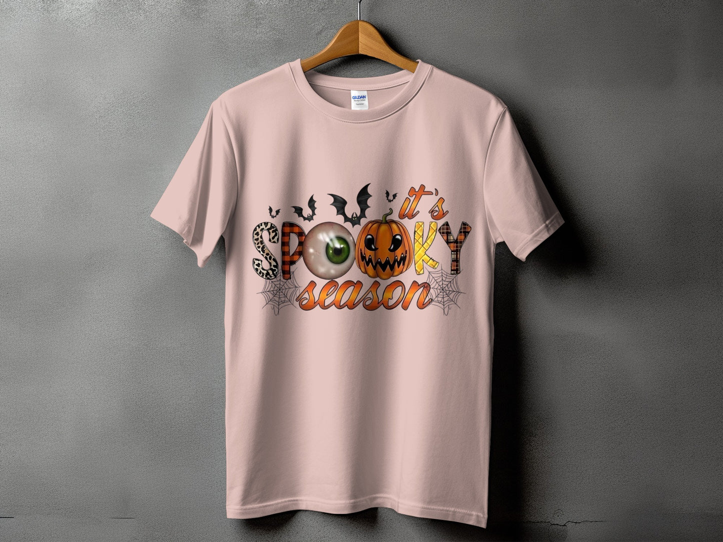 Pink t-shirt with "It's Spooky Season" text and Halloween graphics.