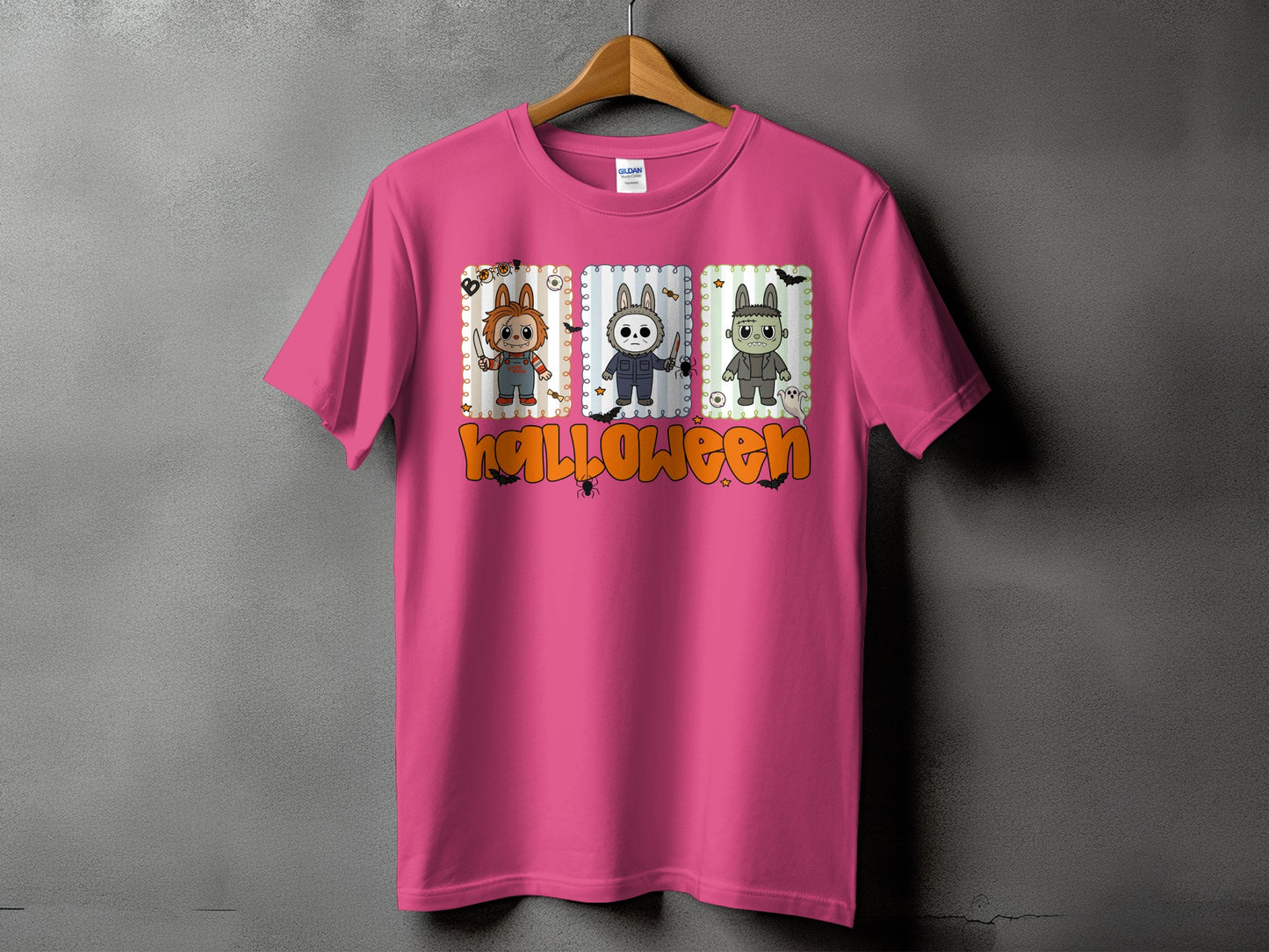Pink t-shirt with Halloween characters and orange text.
