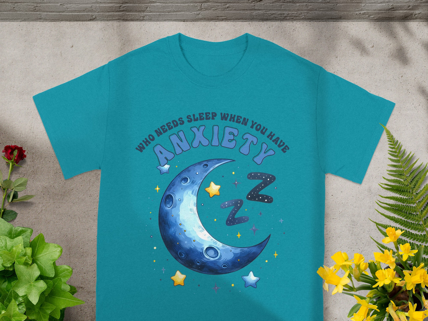 Teal t-shirt with crescent moon, stars, and "Who needs sleep when you have anxiety" text.