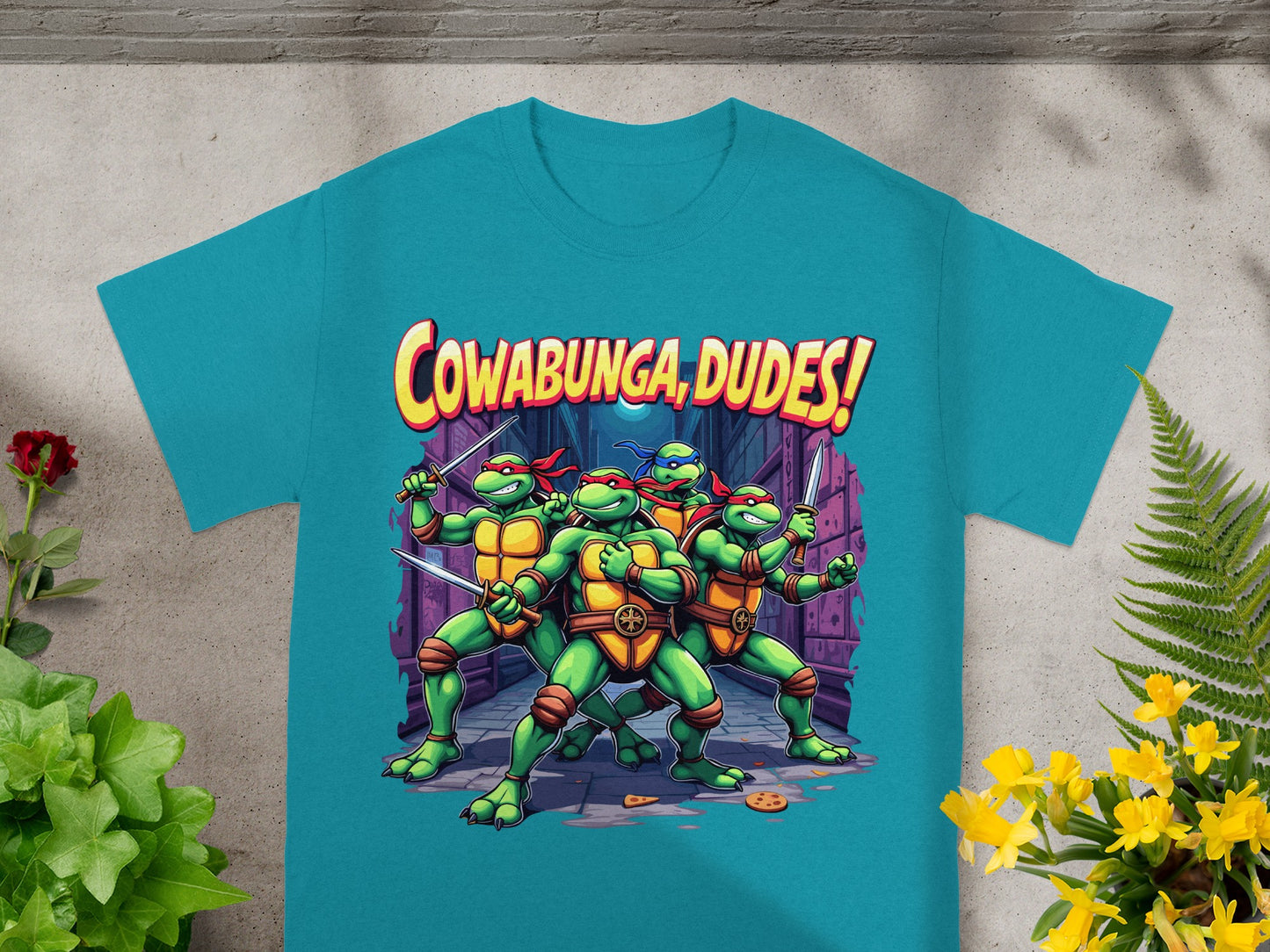 Teenage Mutant Ninja Turtles on t-shirt with "Cowabunga, Dudes!" text.
