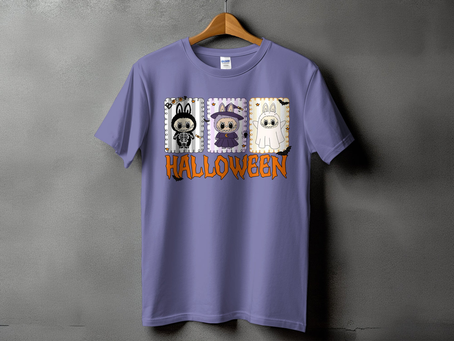 Purple t-shirt with Halloween graphic featuring three cartoon characters and text.