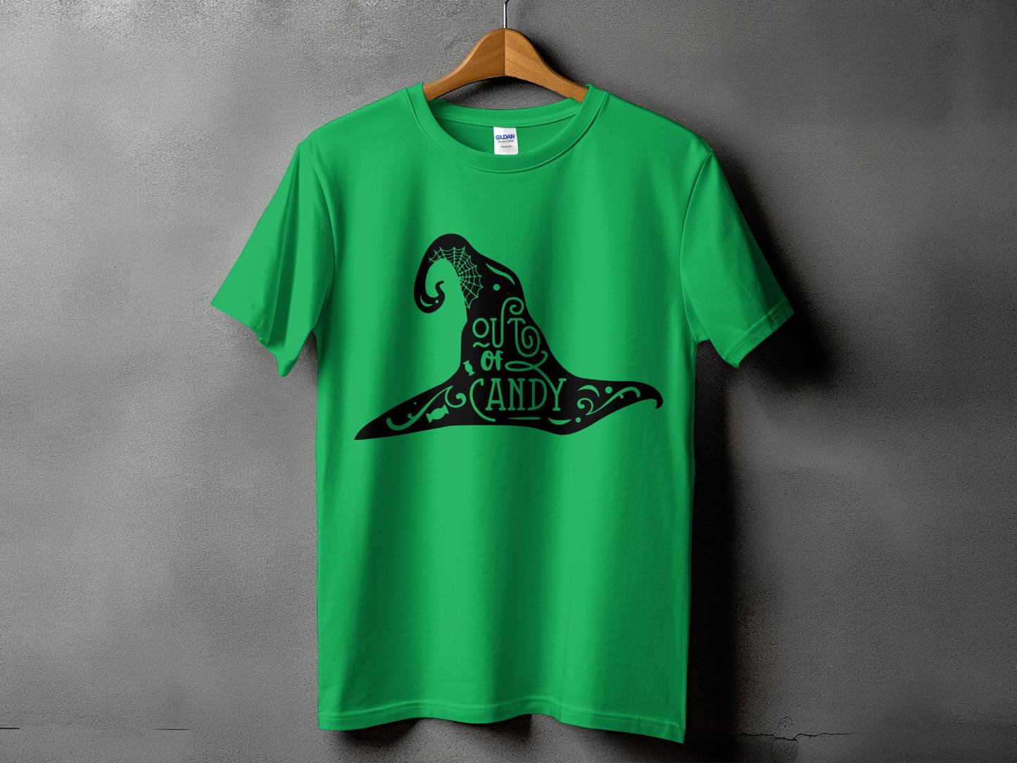 Green t-shirt with black witch hat graphic that reads "out of candy".