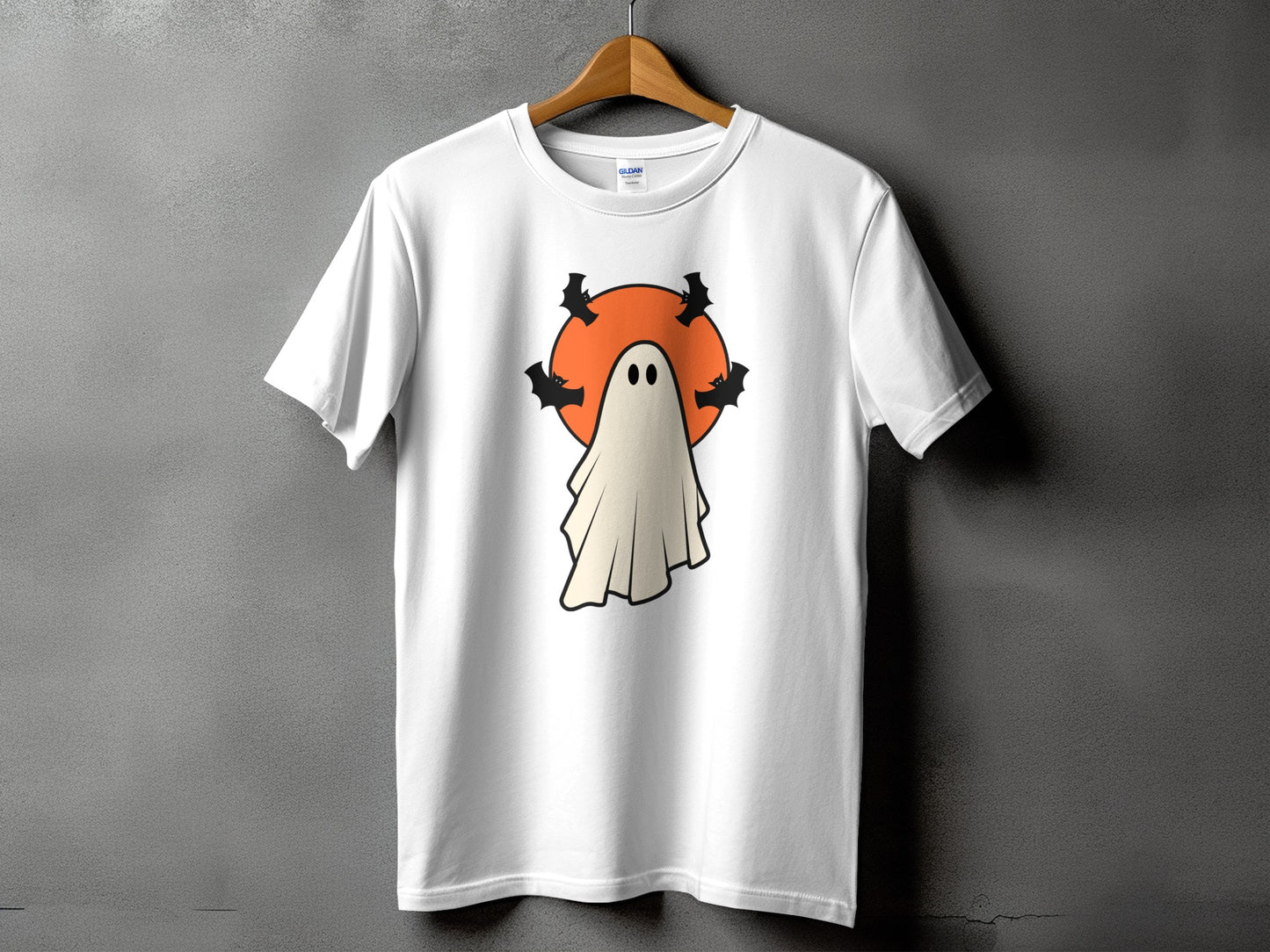 White t-shirt with a graphic of a ghost and bats in front of an orange circle.