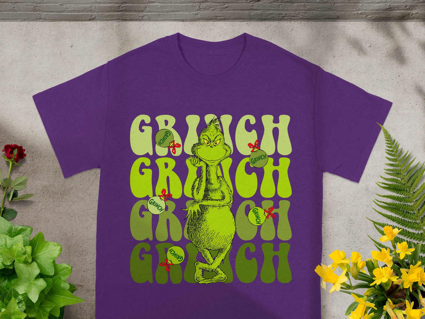 Purple t-shirt with "Grinch" text and character graphic.