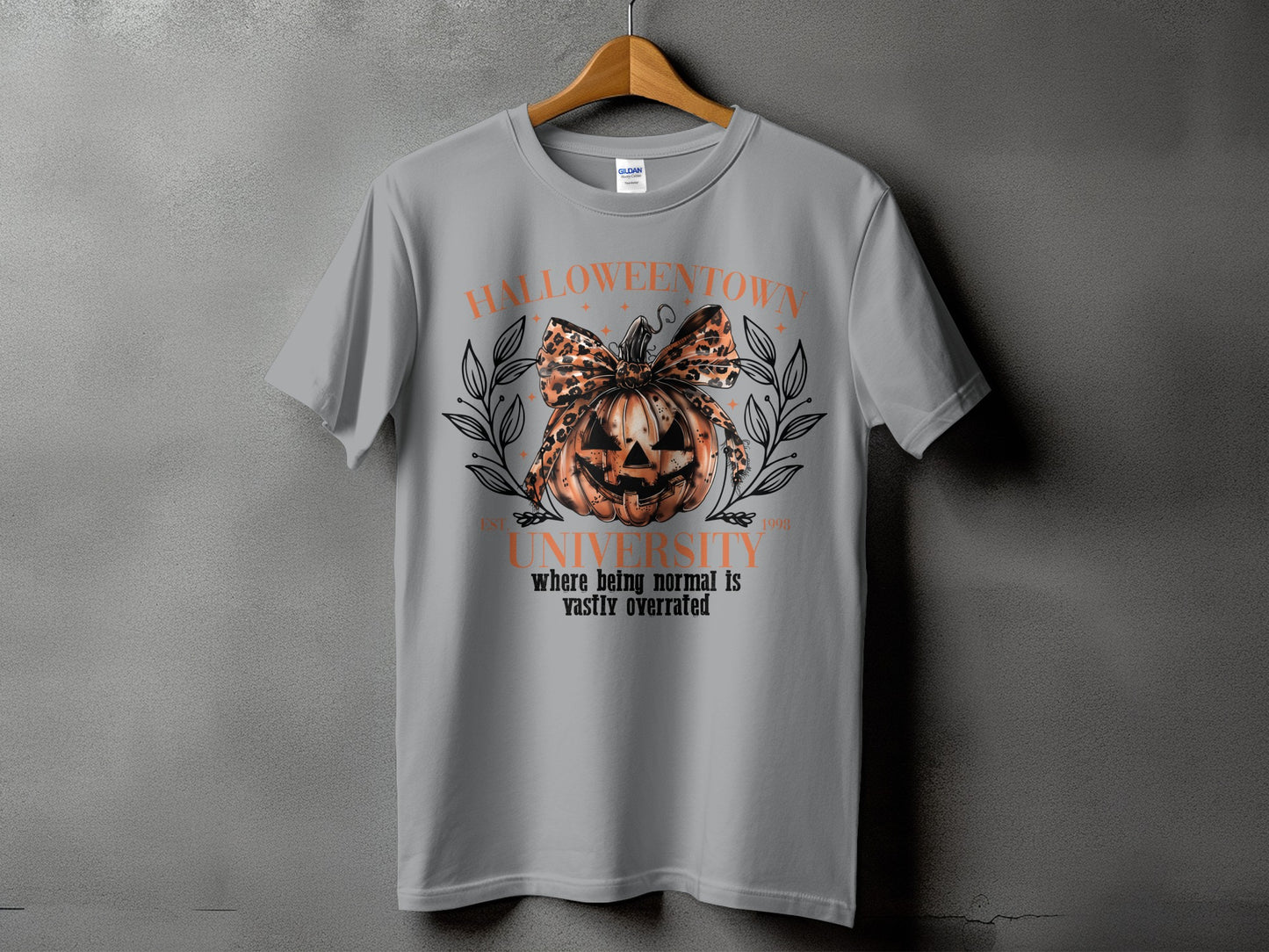 Grey t-shirt with a Halloween graphic featuring a pumpkin with a leopard print bow and the text "Halloweentown University".