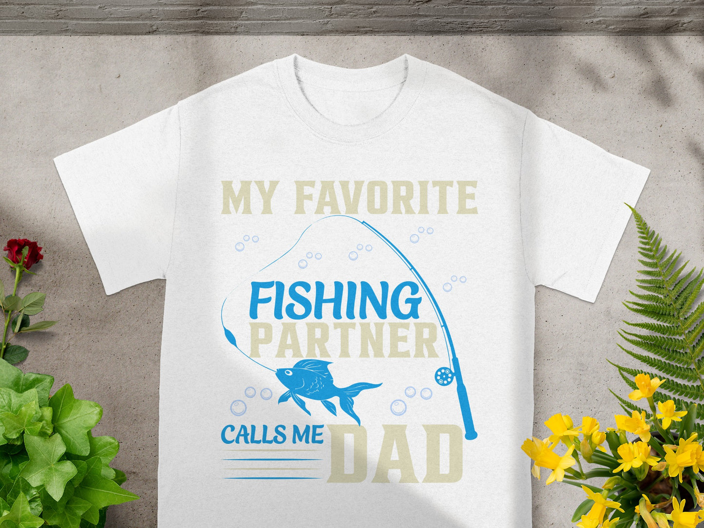 White t-shirt with "My Favorite Fishing Partner Calls Me Dad" text and fishing graphics.