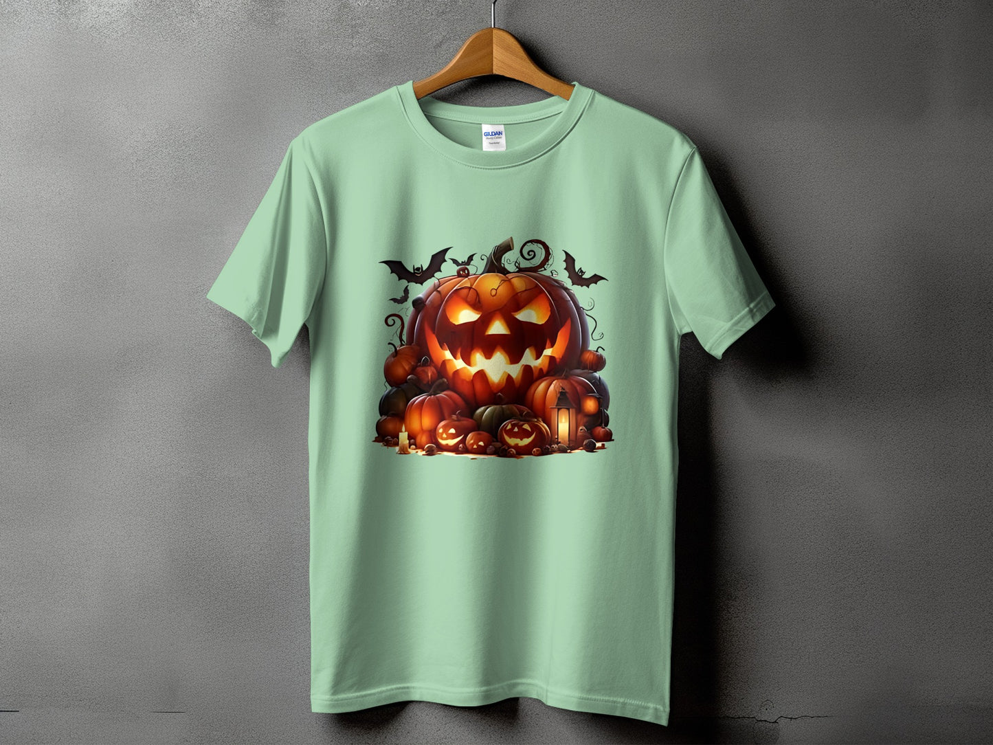 Light green t-shirt with a pile of illuminated jack-o'-lanterns and bats.