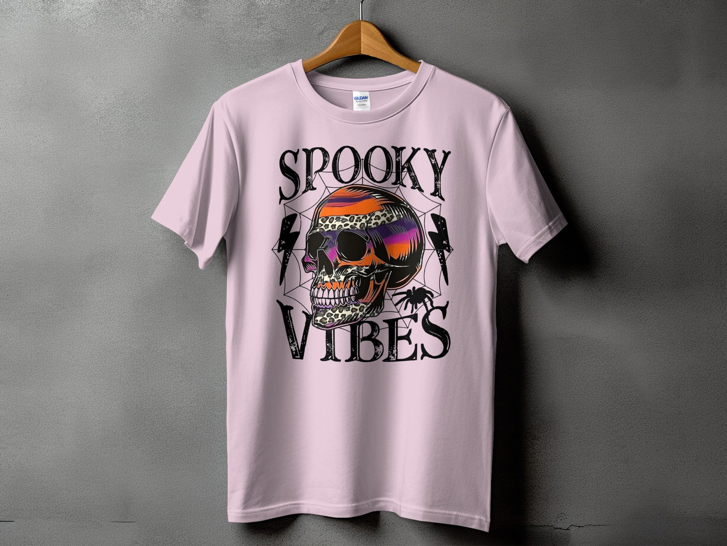 Light pink t-shirt with "Spooky Vibes" and a colorful skull graphic.