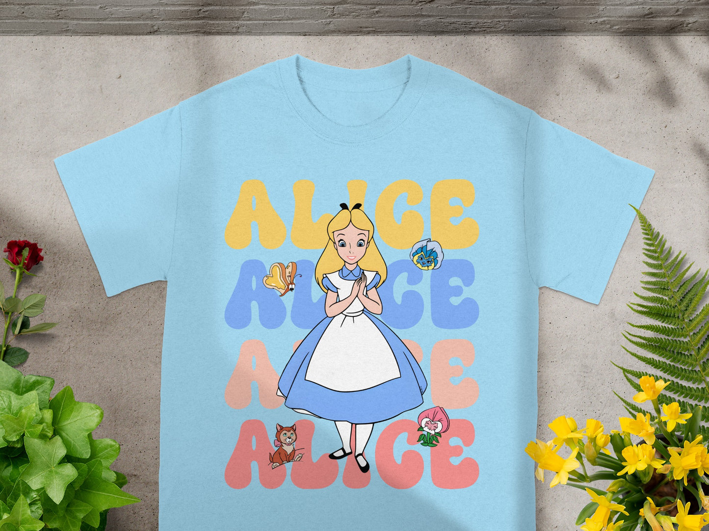 Light blue t-shirt with "ALICE" in colorful letters and Alice in Wonderland characters.