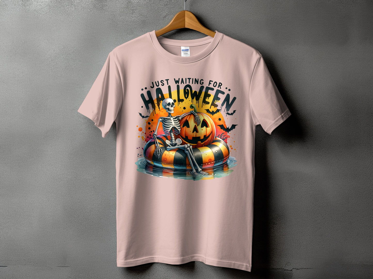 Skeleton on inflatable tube with pumpkin, "Just Waiting for Halloween" text.