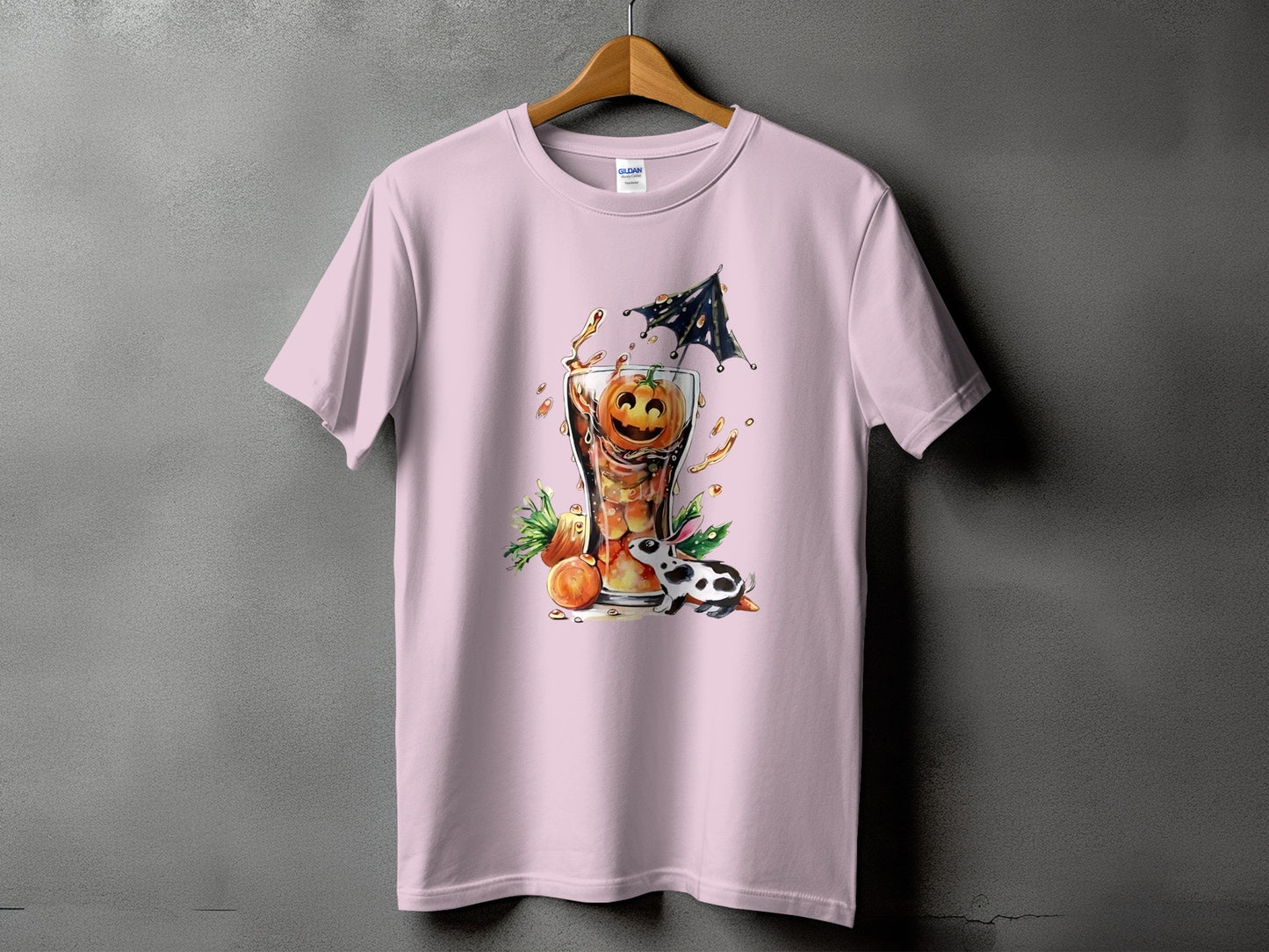 Pink t-shirt with a Halloween graphic of a pumpkin drink and a black and white bunny.