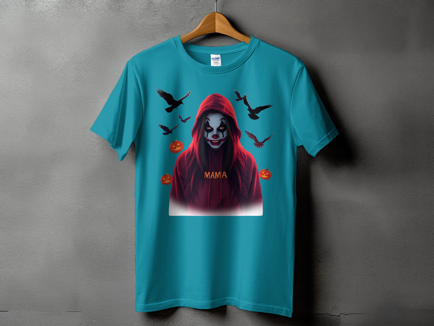 Teal t-shirt with a creepy clown graphic, pumpkins, and flying birds.