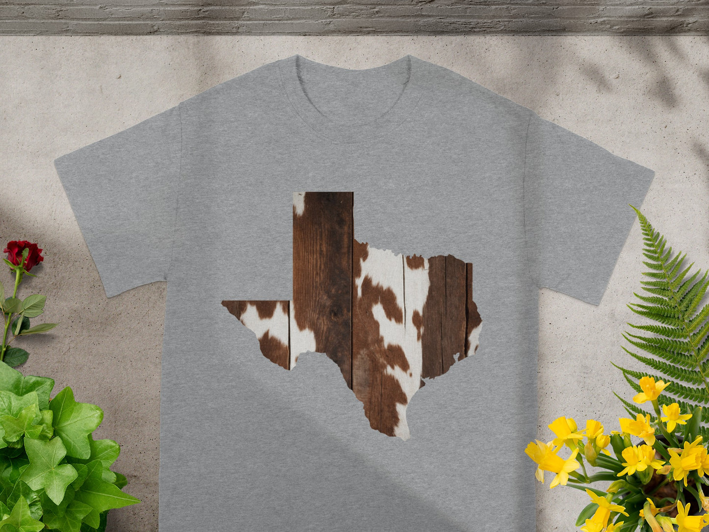 Gray t-shirt with Texas shape graphic in cowhide and wood pattern.
