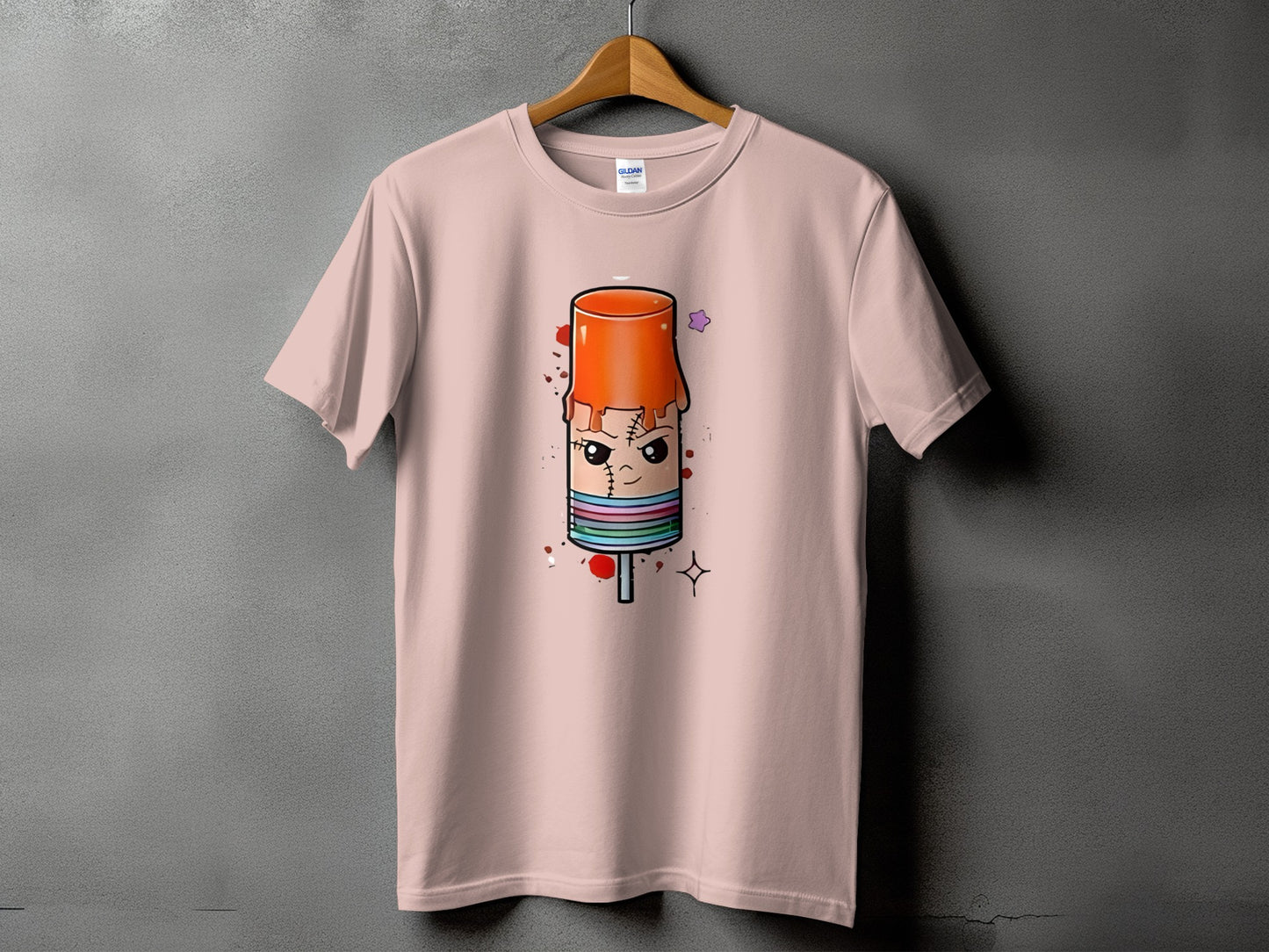 Pink t-shirt with cartoon popsicle graphic featuring stitched lines and colorful stripes.