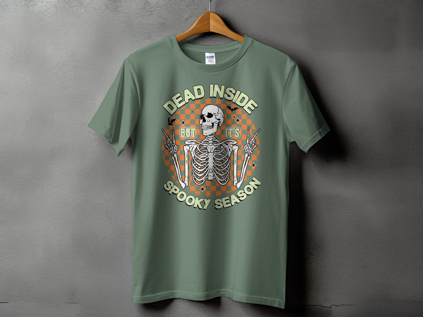 Green t-shirt with skeleton graphic saying "Dead Inside But It's Spooky Season"