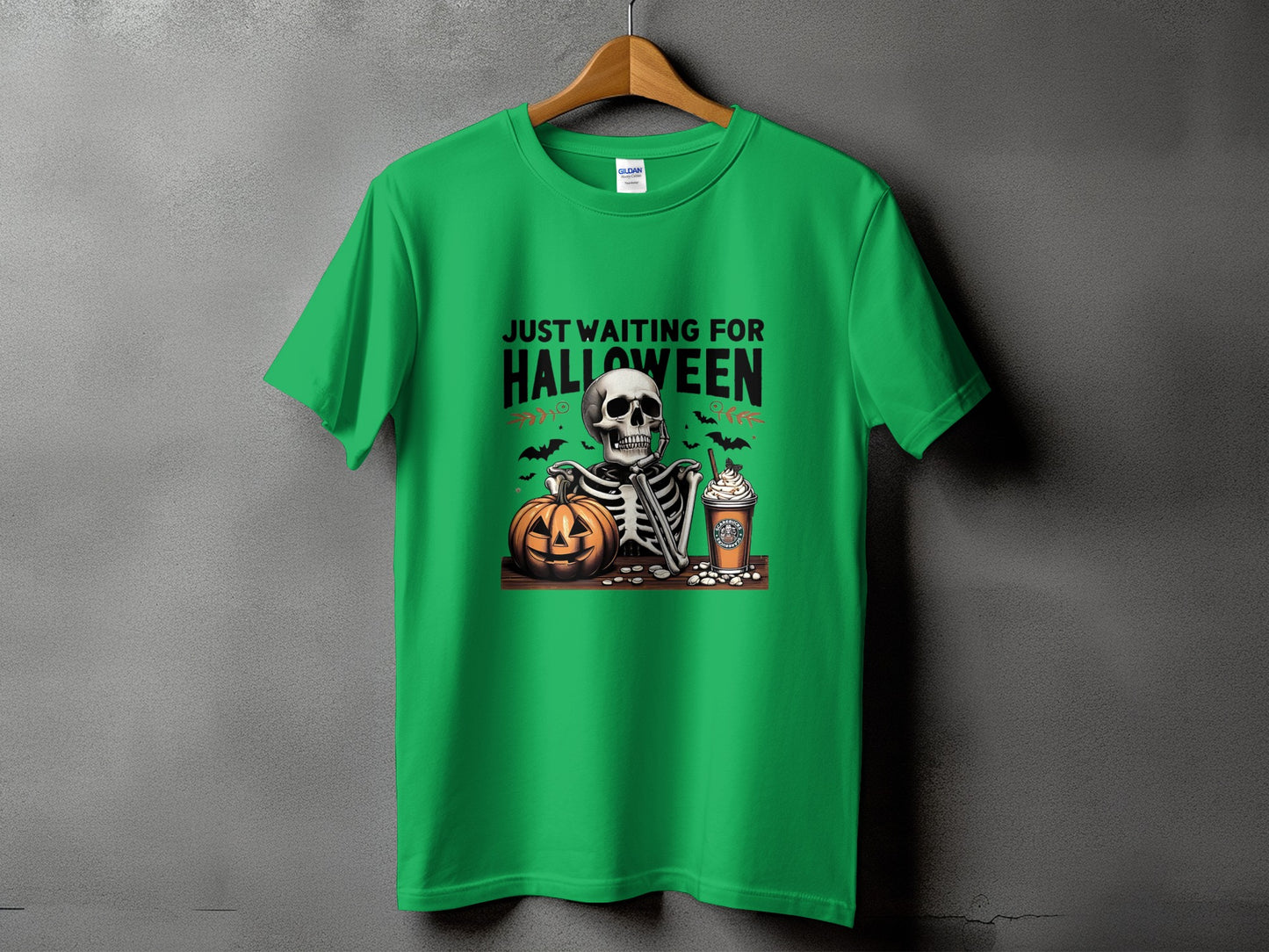 Green t-shirt with skeleton, pumpkin, and coffee cup graphics, text "JUST WAITING FOR HALLOWEEN".
