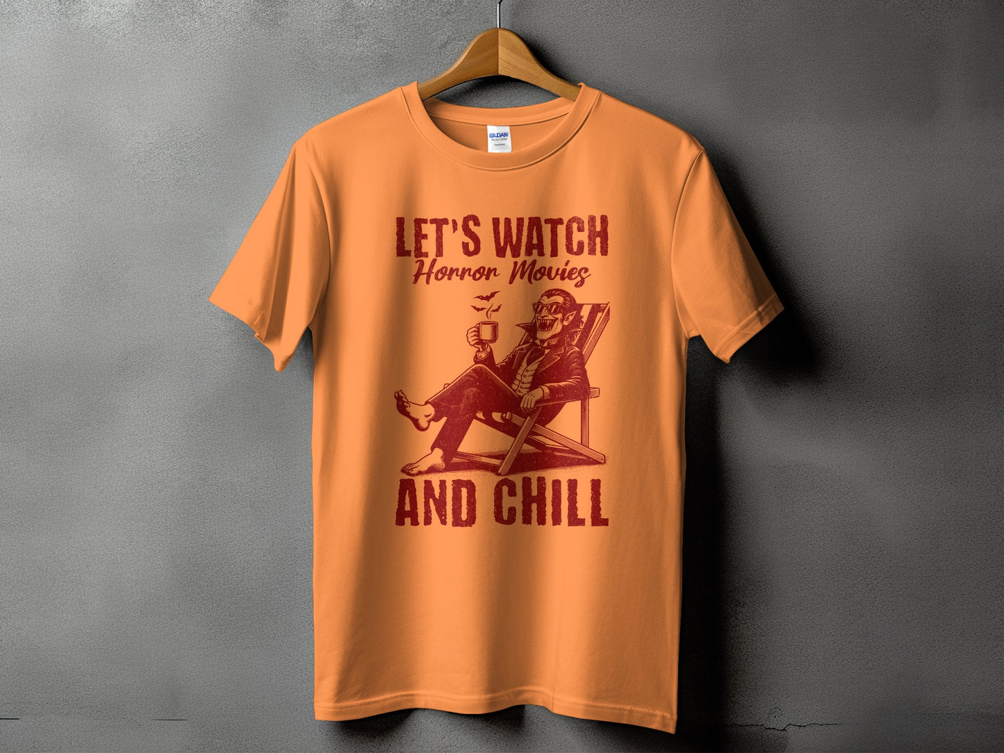 Orange t-shirt with "LET'S WATCH Horror Movies AND CHILL" text and vampire graphic.