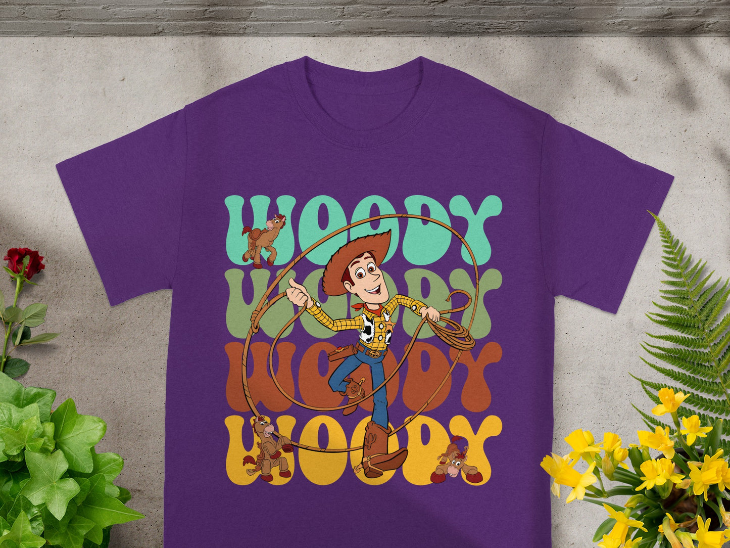 Woody from Toy Story on a purple t-shirt with rope and horse graphics.