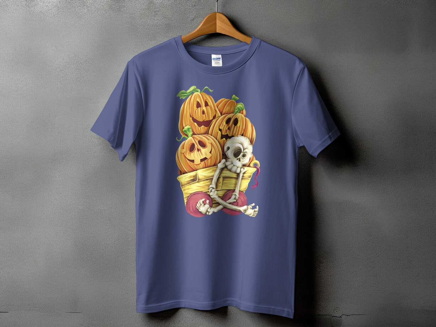 Purple t-shirt with a Halloween graphic of pumpkins and a skeleton in a wagon.