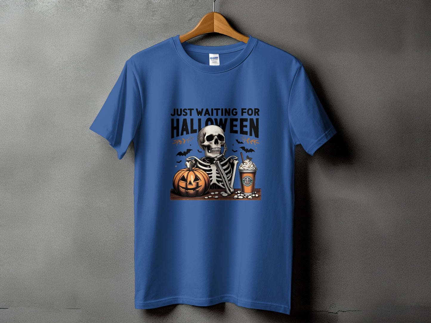 Skeleton, pumpkin, and coffee cup with text "Just Waiting For Halloween".